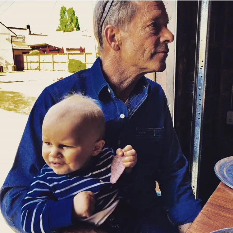 Michael Etzel holding a baby