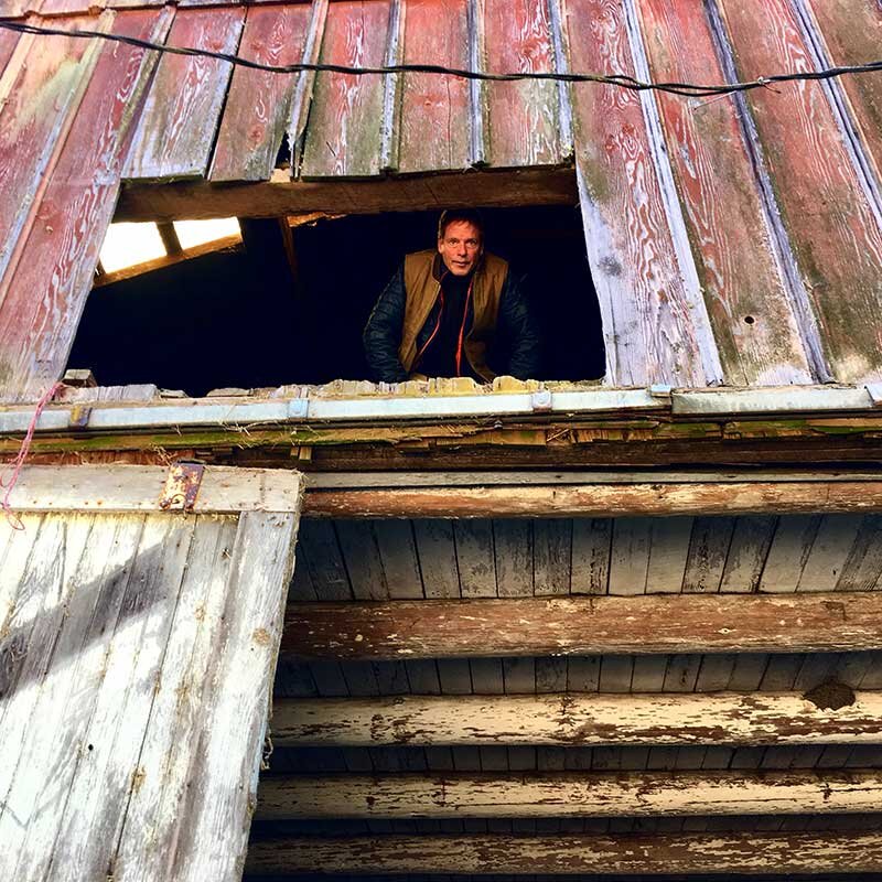 Founder and owner Michael Etzel looking down from a window